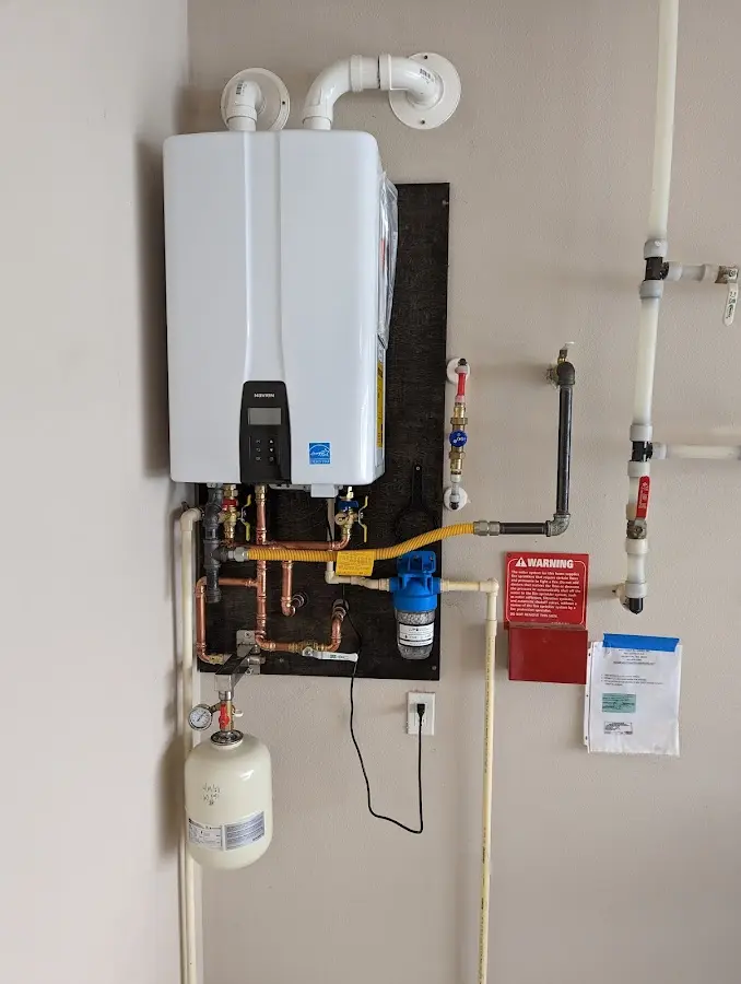 Professional plumber installing copper piping in a Silver Lakes home